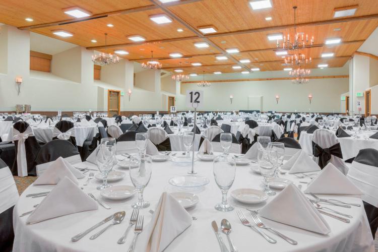 Multiple set tables fill a large conference room for a special event at The Lodge at Big Bear Lake.