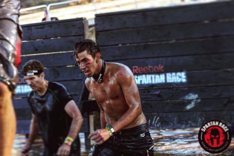Two Spartan racers emerge from a watery obstacle during the Spartan Trifecta Weekend in Big Bear Lake, CA.