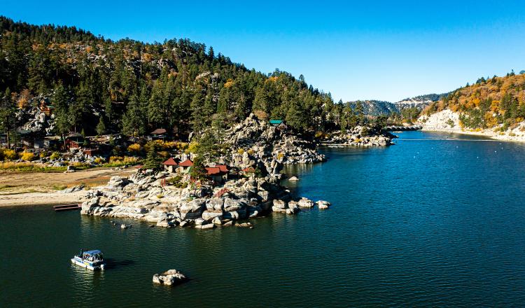 Big Bear Lake surrounded by fall colors in the national forest.
