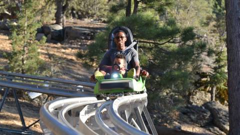 A father rides the Mineshaft Coaster with his daughter in Big Bear, California.